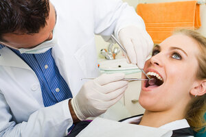 male dentist giving dental exam to female patient McLean, VA conservative dentistry